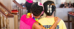 Orientation leaders hug during President's Welcome ceremony
