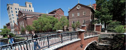 Two people walking across a bridge in Providence