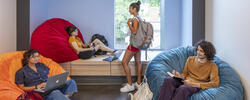 four students hanging out in on-campus housing