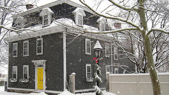Gray house with a yellow door located in the east side of Providence, RI