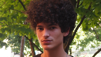 photo of a student outside by a tree