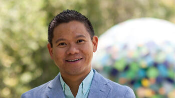 headshot of a man smiling outside