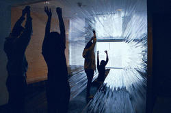 A group of graphic design students interact with an art installation.