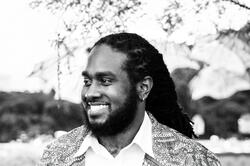 black and white photo of a man smiling to the right