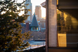 a view from the risd quad of greenery and the tip of carr haus