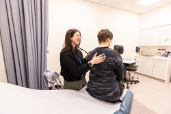 clinician using stethoscope on patient