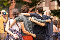 four people side hugging