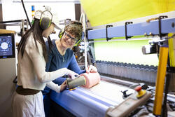 a student and faculty member working together on the Jacquard loom