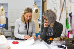 apparel faculty member and student talking over a project