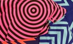 Liz Collins textile patterns in hot pink, red, and blue, with chevron and concentric circle striped patterns