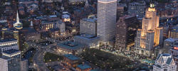 a far overhead view of downtown Providence, with buildings lit up and cars moving on the roads
