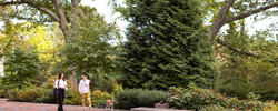 two people walking with a dog by woods gerry
