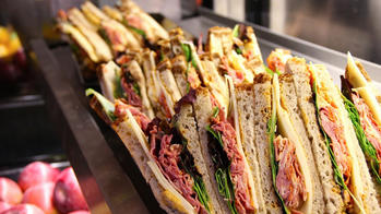 deli sandwiches stacked in a row