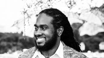 black and white photo of a man smiling to the right