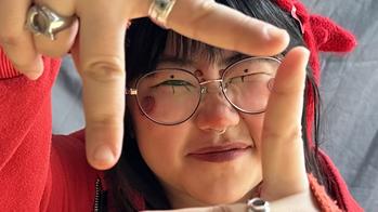 picture of person with hands in front of face