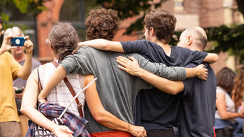 four people side hugging