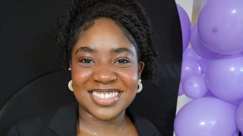 picture of a woman next to purple balloons