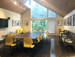 photo of the ISE main lounge, a large room with large window and tables with yellow chairs